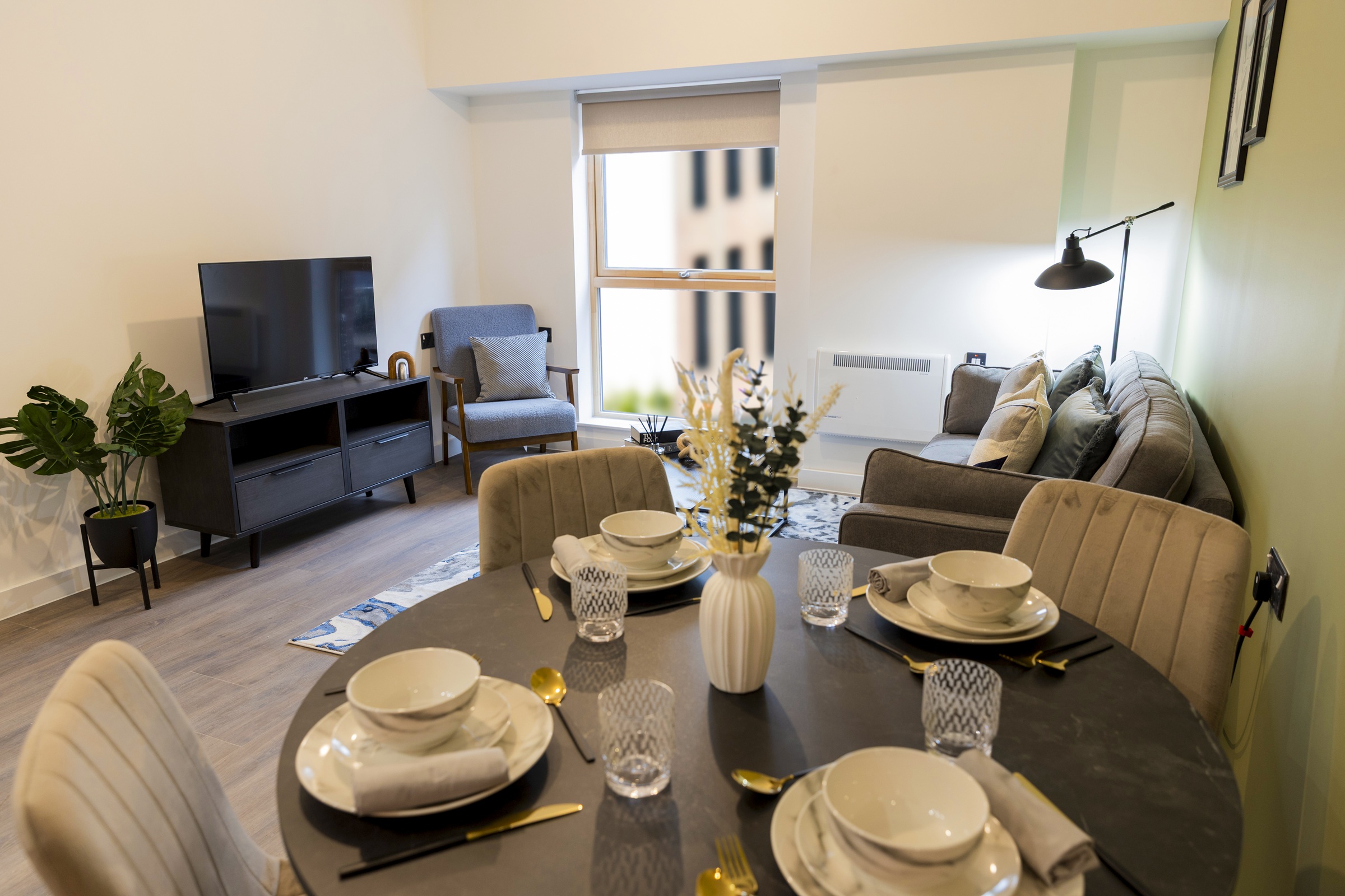 A photograph showing the furnished open plan living room and dining room.