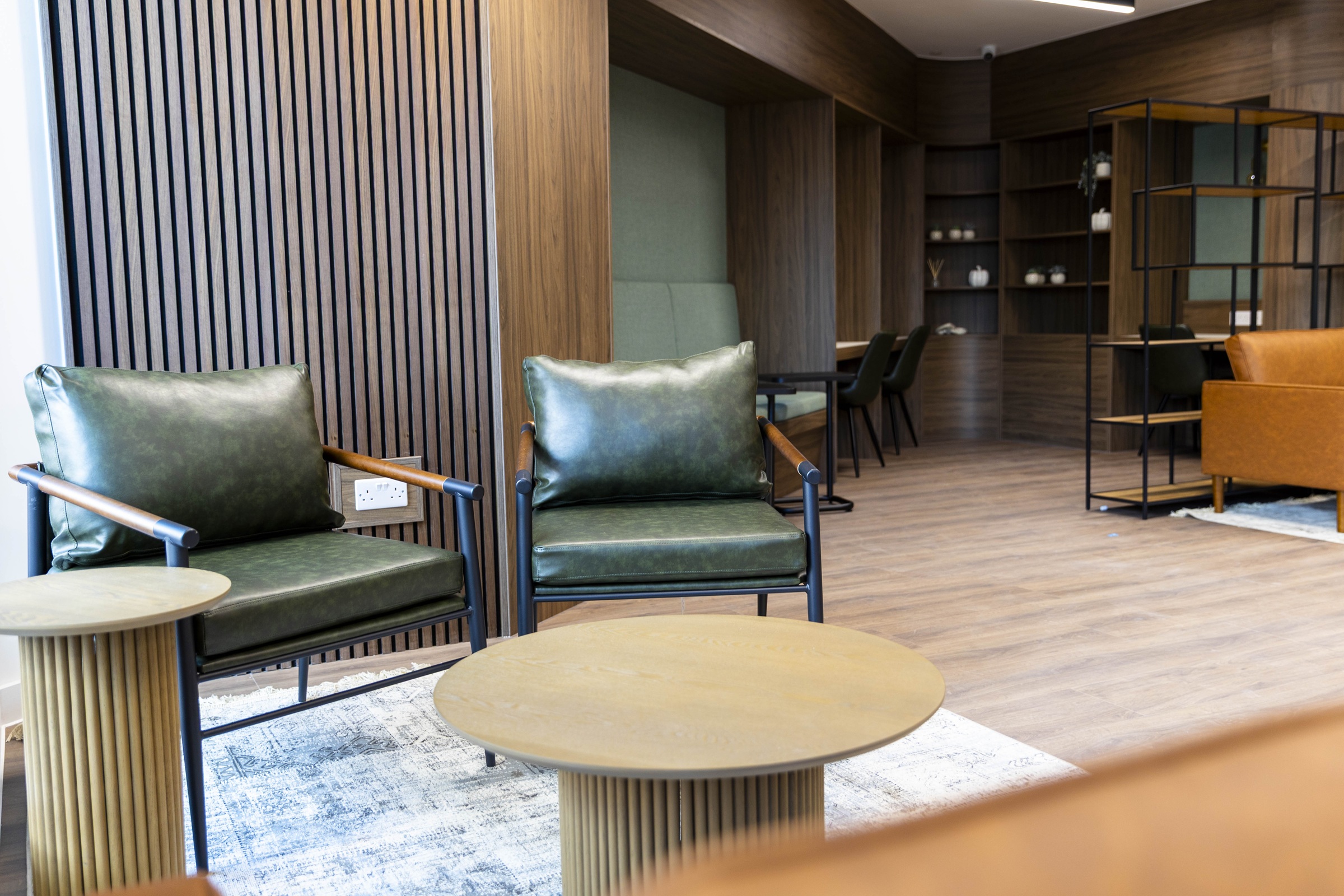 A photograph showing the lounge and work space area of the residents' hub.
