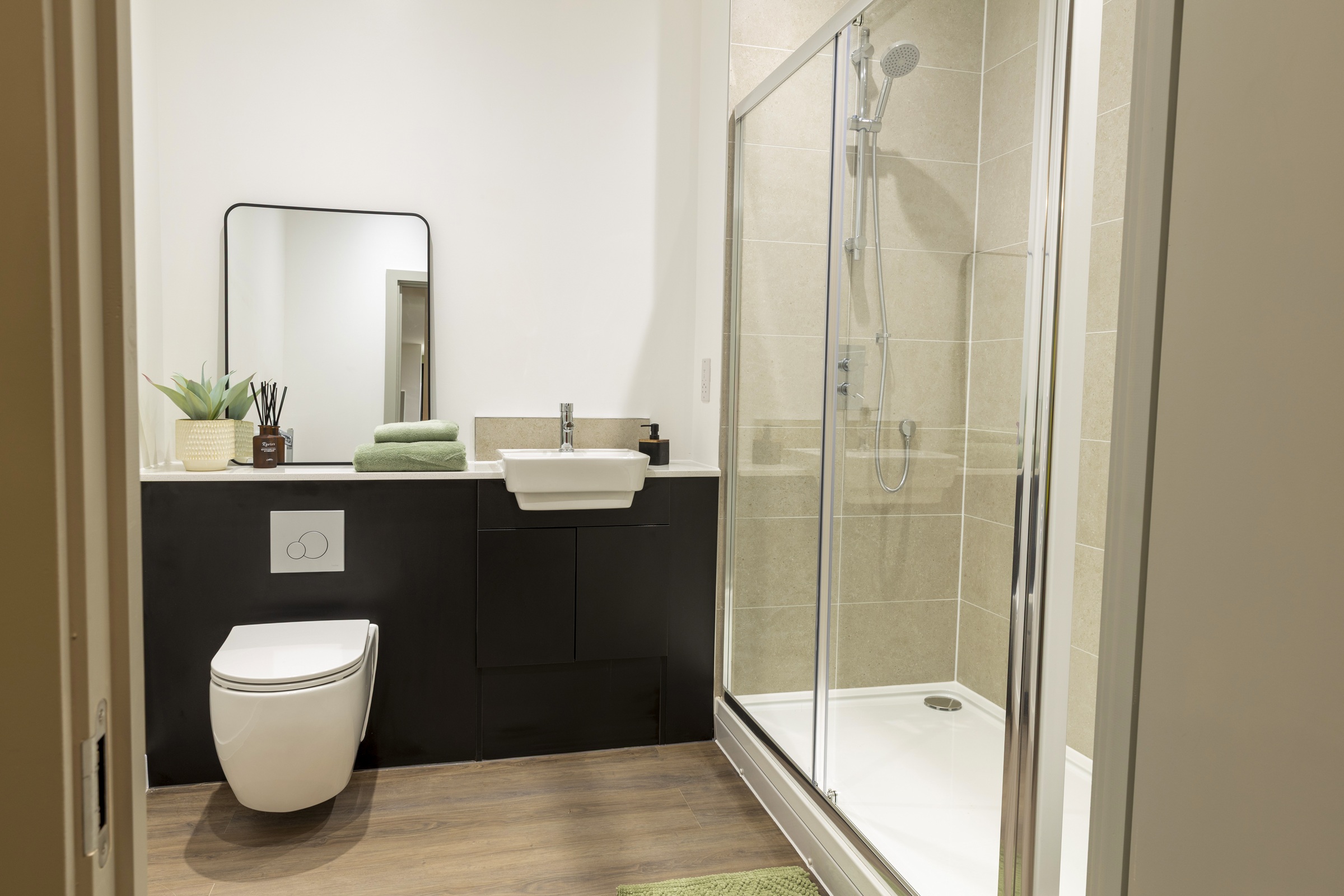 A photograph showing the bathroom's shower cubicle and floating toilet.