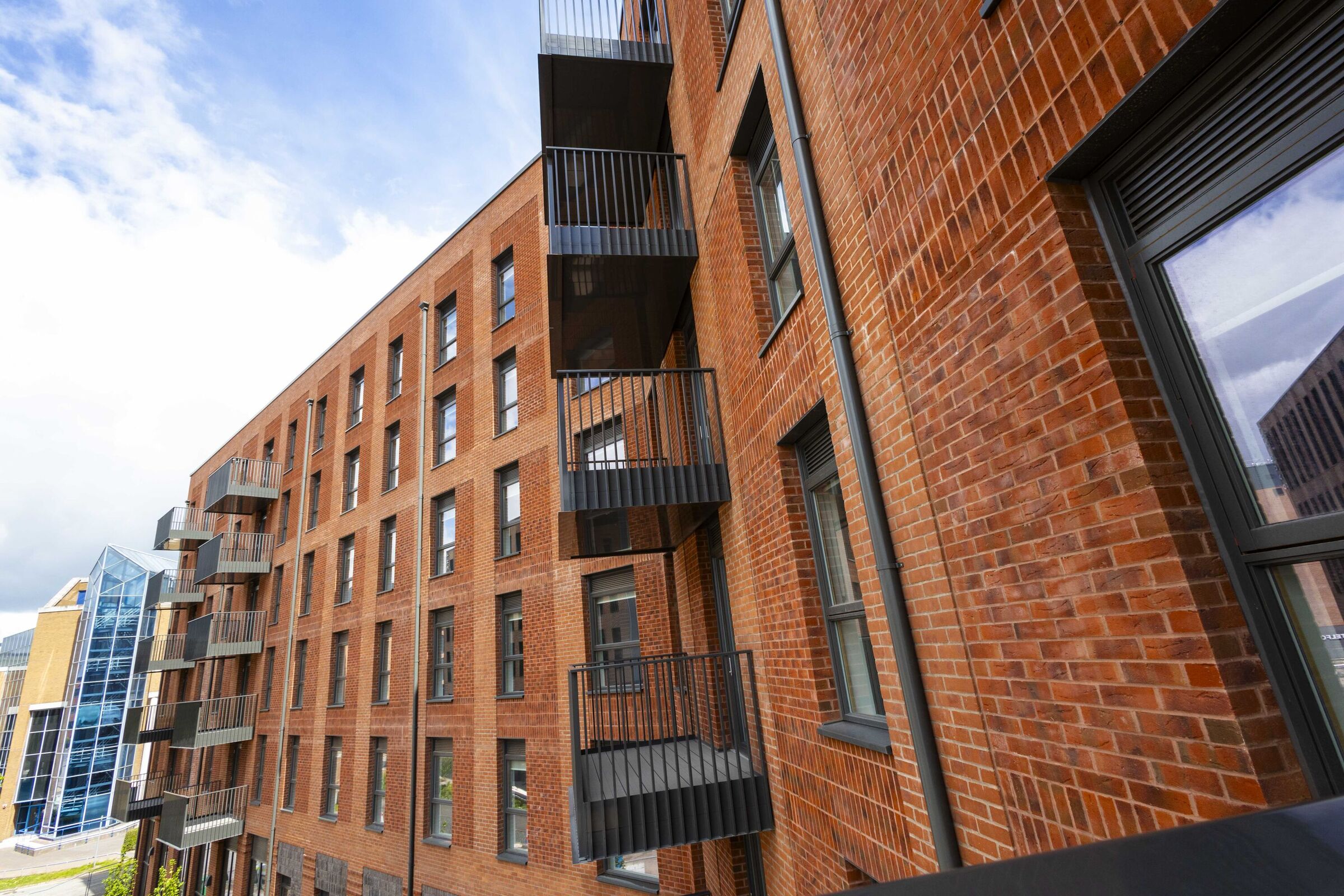A photograph showing the exterior of Denmark House, including the balconies on select preoperties.