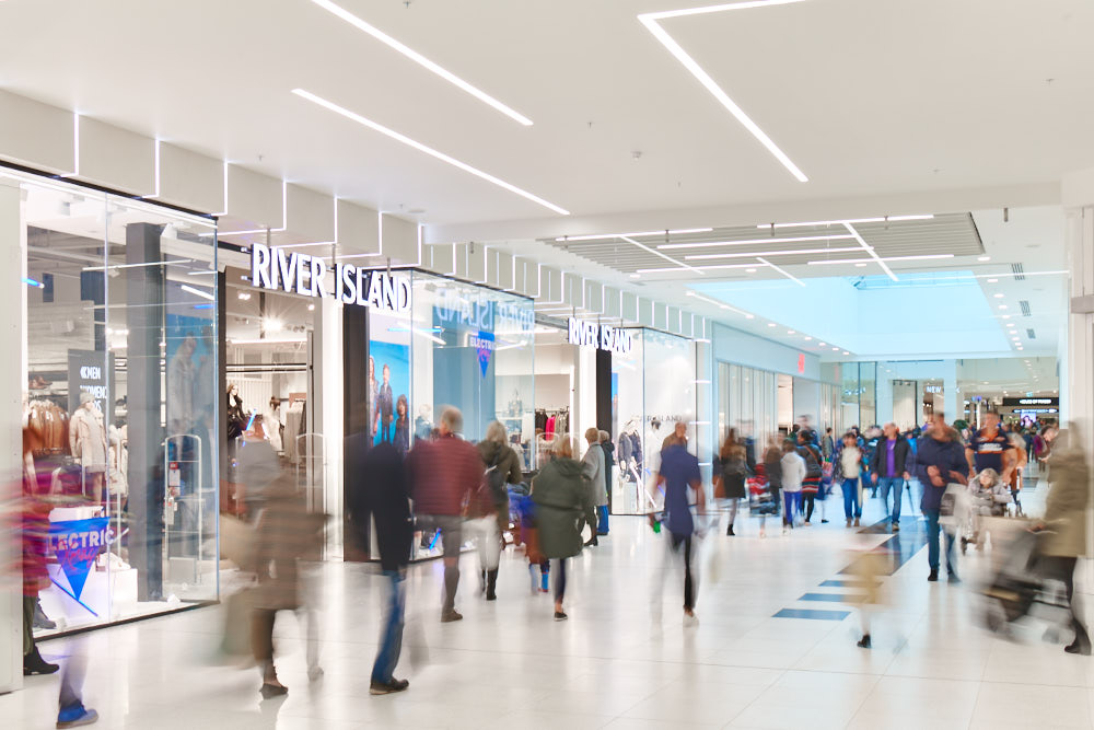 A long exposure photograph showing shoppers walking through Telford Shopping Centre.